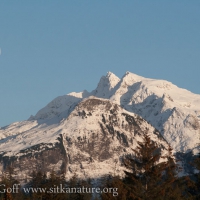 Moon over Snow-covered Mountains